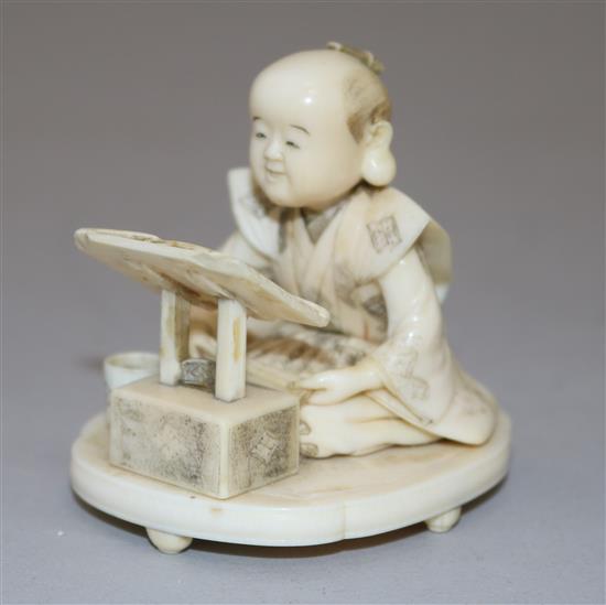 A Japanese Meiji ivory okimono of a scribe, 2.5in.